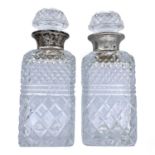 A pair of modern cut glass whisky decanters and stoppers with silver rims, London 1959, height