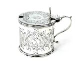 A Victorian silver mustard pot by Arthur Sibley, with scallop shell thumb piece and bright cut