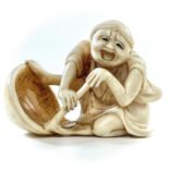 A Japanese Meiji period carved ivory okimono of a drunken brewer, height 3.5cm, width 4.75cm.***This