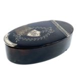 A Georgian tortoiseshell silver inlaid oval snuff box, the hinged lid with silver thumbpiece and