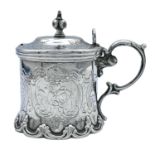 A Victorian silver mustard pot, maker JE, of cylindrical form with foliate scroll decoration, scroll