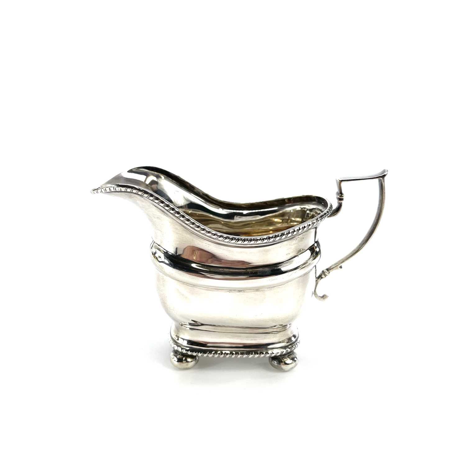 A George V silver three piece tea set by Thomas Bradbury & Sons Ltd, of oblong form with gadrooned - Image 9 of 10