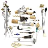 A collection of hatpins including a silver and amethyst thistle hatpit by Charles Horner, Chester