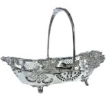 An attractive Edwardian silver swing handled bread basket by Harrison Fisher, with foliate