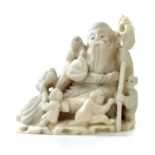 A Japanese Meiji period carved ivory okimono depicting Shoulao and five boys, height 4cm, width 4.