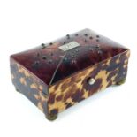 A 19th century tortoiseshell hinge lidded trinket box, the slightly domed lid quarter veneered