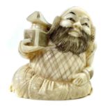 A Japanese Meiji period carved ivory okimono depicting a seated warrior holding a lantern, signed,