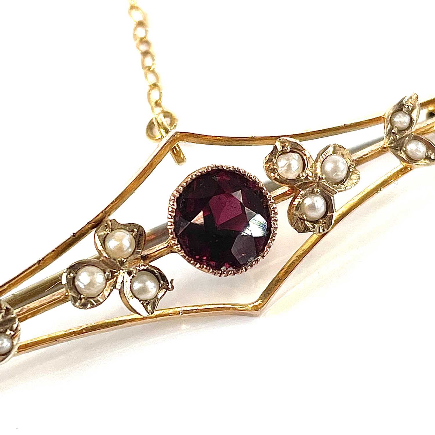 A 9ct gold garnet and seed pearl set bar brooch, base metal pin, width 57mm, weight 3.75g. - Image 7 of 7