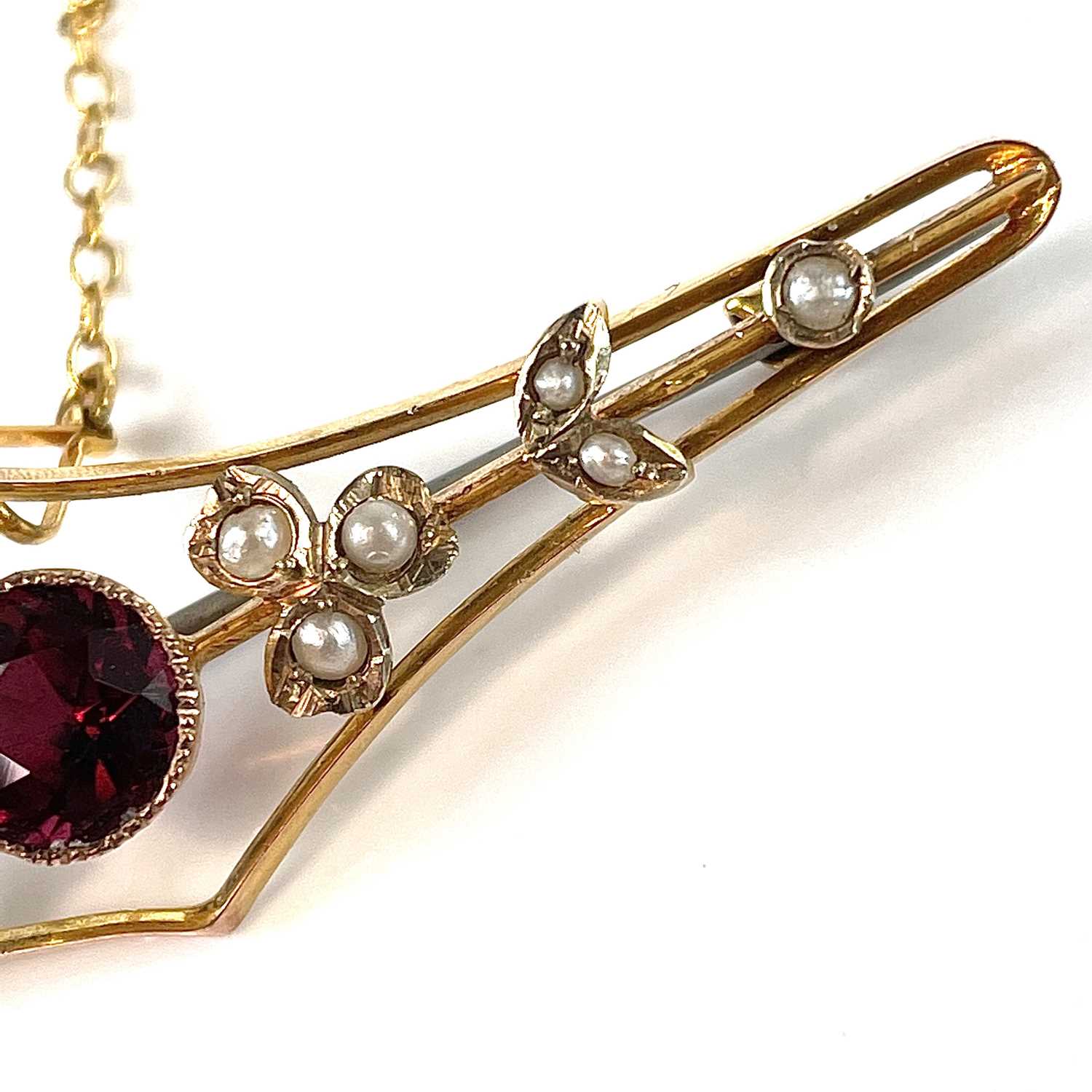 A 9ct gold garnet and seed pearl set bar brooch, base metal pin, width 57mm, weight 3.75g. - Image 3 of 7