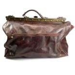 An Italian brown leather holdall bag with brass fittings, width 52cm.