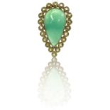 An eccentric but stylish large 18ct gold green jade and peridot dress ring, the pear shaped cabochon