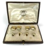 An 18ct shirt studs and cufflinks matched set with four plain studs and oval cufflinks, the