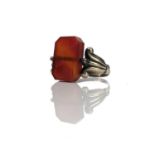 A 19th century gold carnelian set intaglio swival ring, one side carved with a dog, the other a