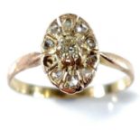 An antique gold and diamond set cluster ring, the oval head with a central diamond measuring 0.