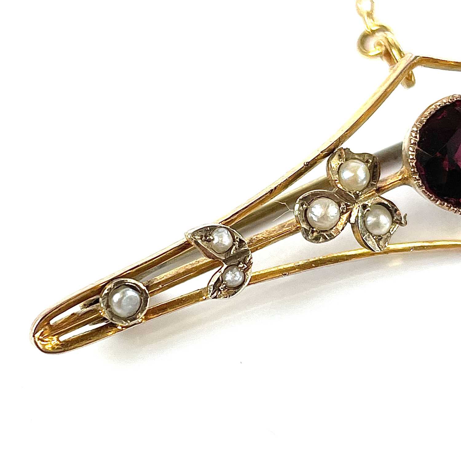 A 9ct gold garnet and seed pearl set bar brooch, base metal pin, width 57mm, weight 3.75g. - Image 6 of 7