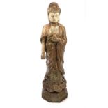 A Chinese carved and painted wood figure of a Buddhist Divinity, circa 1900, standing in robes