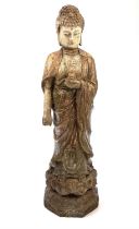 A Chinese carved and painted wood figure of a Buddhist Divinity, circa 1900, standing in robes