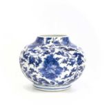 A Chinese blue and white porcelain squat vase, Kangxi Period, with leafy, flowering scrolling vines,