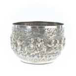 A large Burmese silver bowl, 19th century, repousse decorated with sixteen figures in high relief