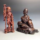 A Chinese hardwood carved figure of a man with a tiger, 19th century, complete with original
