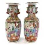 A pair of Chinese Canton porcelain vases, 19th century, each with a panel enclosing figures in an