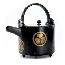 A Japanese lacquer saki kettle, Meiji Period, with swing handle, the hinged cover surmounted by a