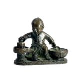 A Chinese bronze figuire of a boy, early 20th century, height 6.5cm, width 7.5cm, depth 3.5cm.