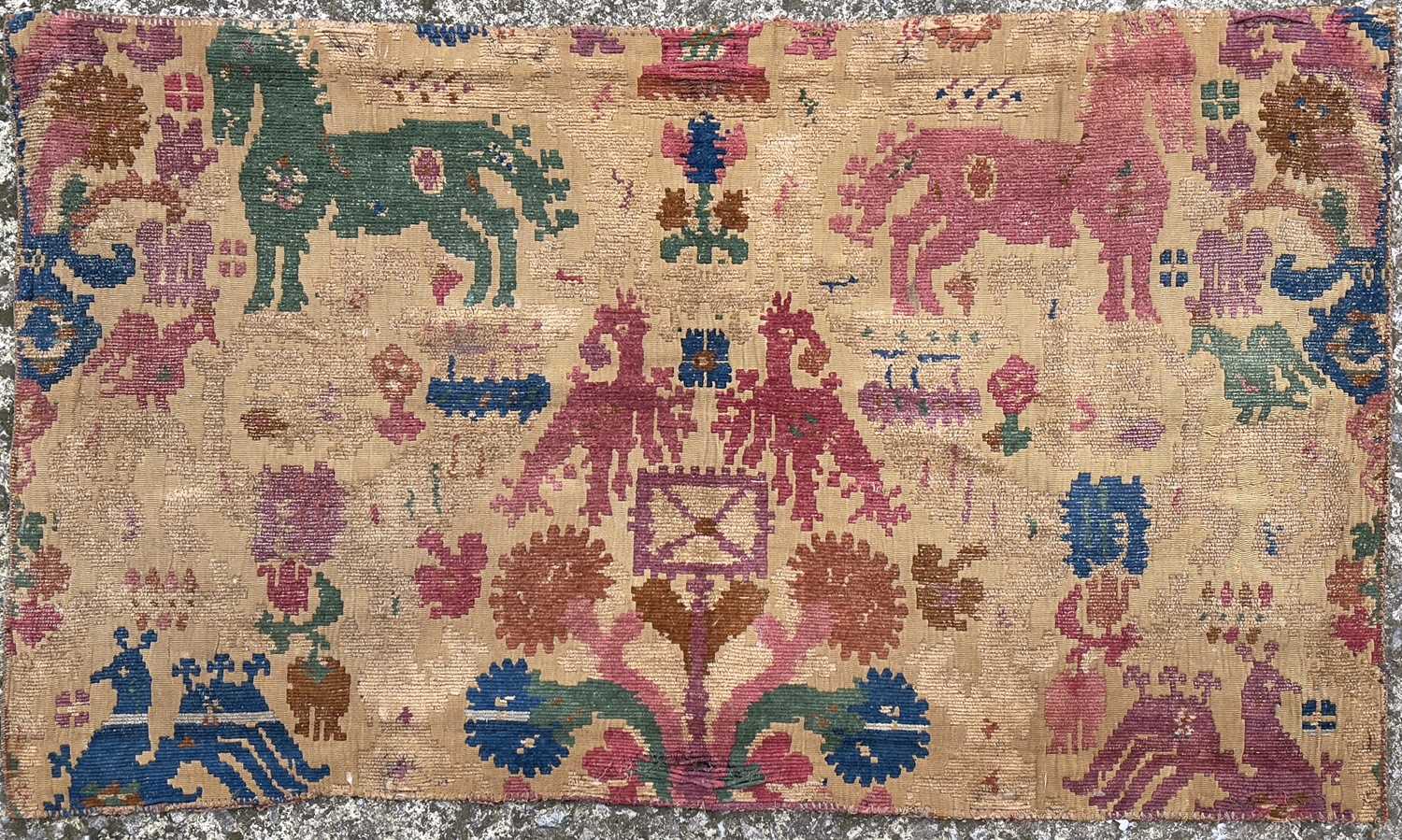 A wool on cotton tapestry fragment, 19th century, possibly Anatolian, decorated with horses,