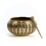A Tibetan mixed metal singing bowl, height 10cm, diameter 18cm and hammer. (2)some marks to the