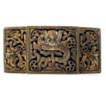 A Chinese brass buckle, circa 1900, with pierced dragon decoration, 3.5 x 7cm.Evidence of gilding.