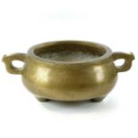 A Chinese polished bronze censer, seal mark, with a pair of loop handles and bulbous body, on