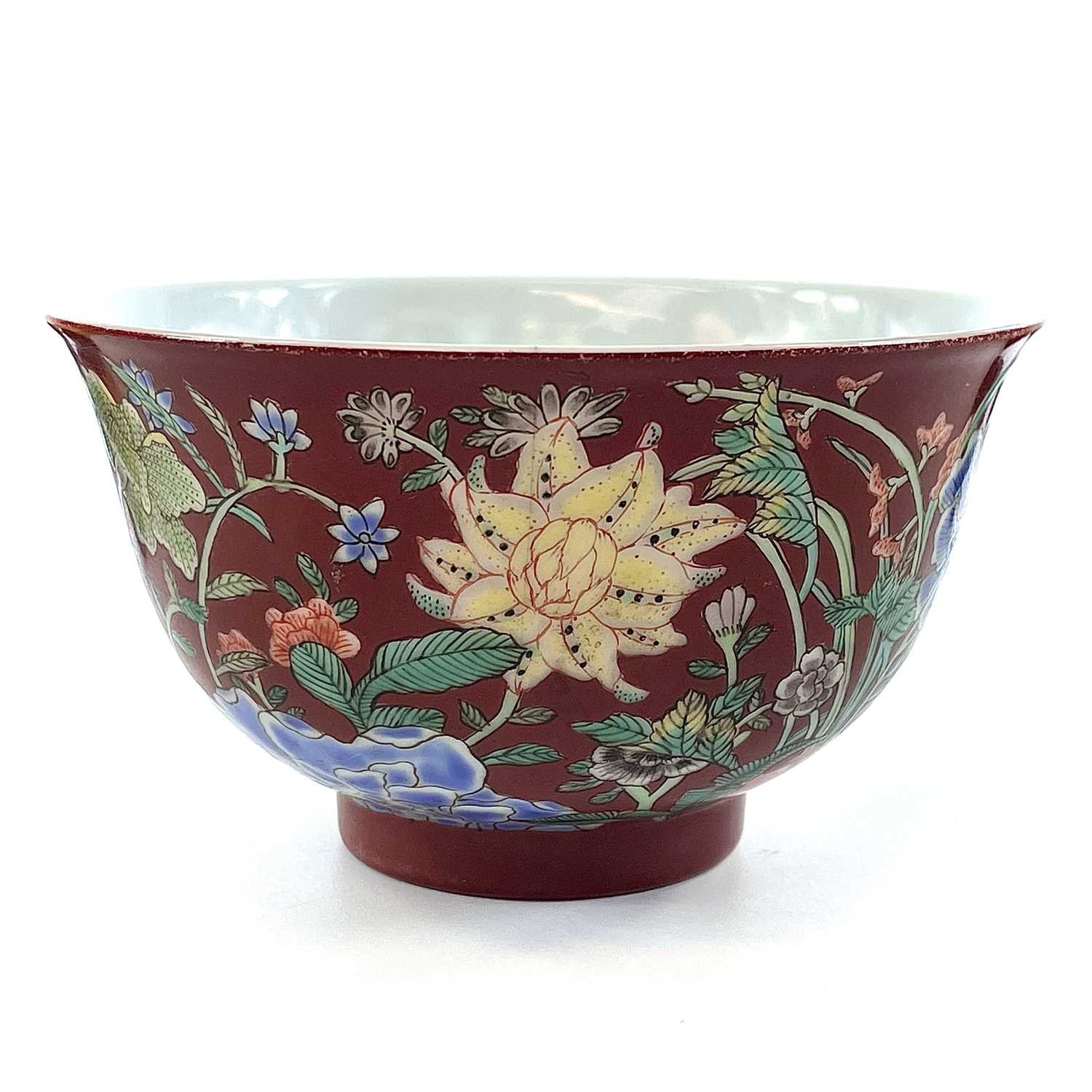 A Chinese famille rose porcelain bowl, 20th century, the coral ground decorated with foliage, height