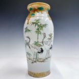 A Japanese porcelain baluster vase, Meiji period, painted with cranes and bamboo, height 31.5cm,
