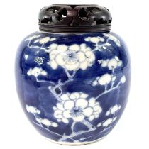 A Chinese prunus blossum pattern porcelain ginger jar, late 19th century, with pierced wood cover,