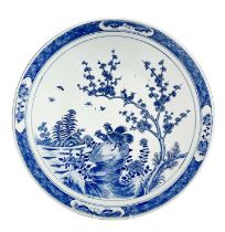 A Chinese blue and white porcelain charger, 19th century, with birds perched on a blossoming tree