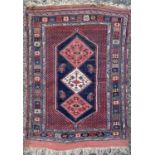 An Afshar rug, South West Persia, circa 1920's, the madder field with a large indigo medallion