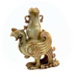 A Chinese jade carved model of a phoenix, 20th century, supporting an archaic vase, height 22cm,