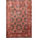 An Afghan rug, circa 1930's, with four rows of two lobed medallions, within a flowerhead and