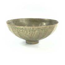 A Chinese celadon bowl, Song Dynasty, of fluted conical form and an all over crackle green glaze,