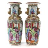 A pair of Chinese Canton porcelain vases, 19th century, each with a panel enclosing figures in an