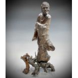 A Chinese carved rootwood figure of a man in a robe, 19th century, the figure in two sections,