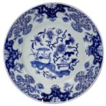 A Chinese blue and white porcelain charger, mid 18th century, decorated with vases of flowers within