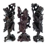 A pair of Chinese carved hardwood figures, late 19th century, each of a man with a staff, height