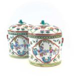 A near pair of Chinese famille rose porcelain cylindrical jars and covers, 20th century, each with