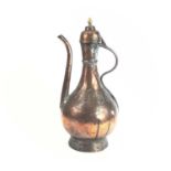An Islamic tinned copper ewer, 19th century, height 37.5cm, width 18cm.