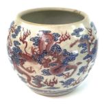A Chinese blue, white and copper red porcelain fish tank / jardiniere, decorated with dragons and