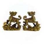 A pair of Chinese gilt metal scroll weights in the form of dogs of fo, height 8.3cm, width 8cm,