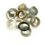 Twelve Chinese miscellanous jade rings, approx 2.5cm.