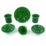 Two Peking green glass cups and saucers, one single saucer and one cup. (6)