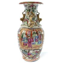 A Chinese Canton porcelain vase, 19th century, with numerous panels enclosing figures, height 23cm.